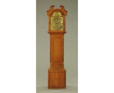 A George III oak longcase clock, with swans neck pediment above the arched glazed door enclosing the brass dial and eight day