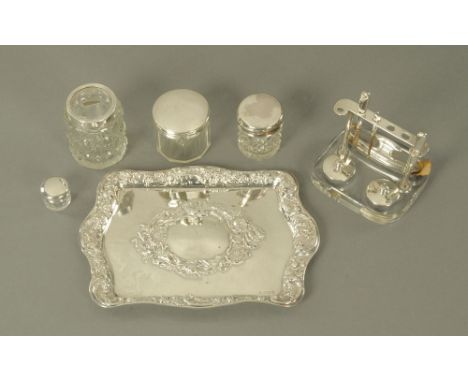 A silver dressing table tray, repousse with foliage and scrolls, Birmingham mark 1906.  195 grams, together with four silver 