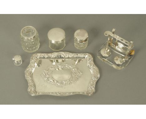 A silver dressing table tray, repousse with foliage and scrolls, Birmingham mark 1906.  195 grams, together with four silver 