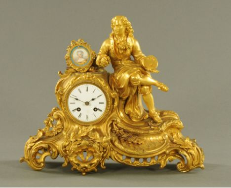 A 19th century French ormolu mantle clock, with artist seated next to a portrait panel, the movement a later quartz replaceme