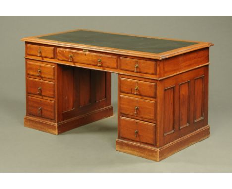 A late 19th/early 20th century mahogany pedestal desk, with tooled leather writing surface, moulded edge and three frieze dra