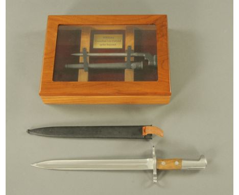 A Second World War cased Lee Enfield spiked bayonet, together with a Swiss Army bayonet.
