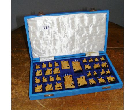 A c.1920's Indian sandalwood chess set in fitted case, carved as figures on the back of elephants and camels.