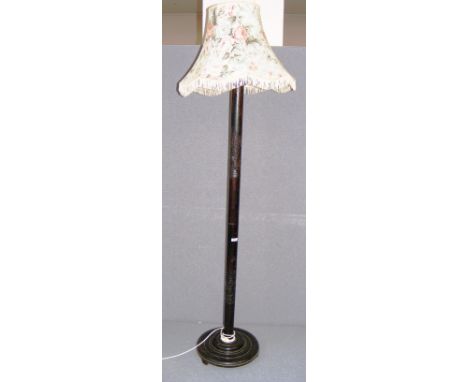 A early to mid 20th century Chinese standard lamp, profusely carved with figures and decoration, on a round base with floral 