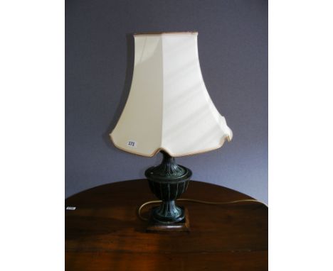 A modern metal table lamp and shade.
