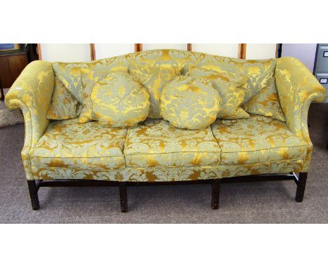 A Victorian Chippendale style camelback sofa upholstered in a floral yellow/green, standing  Chinoiserie style carved legs.