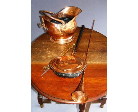 A mixed lot of Victorian copper wares including a coal bucket, warming pan, bugle etc.