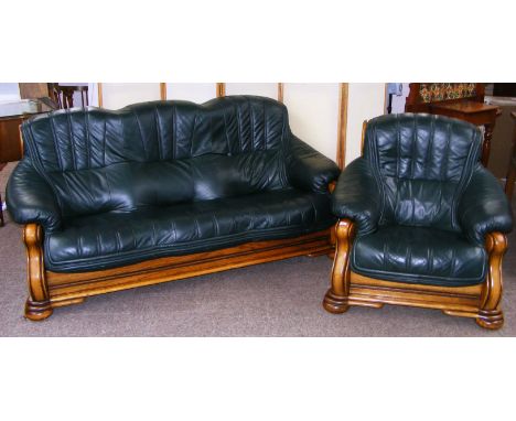 A good quality green leather three seater sofa and single chair, on a solid oak frame.