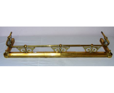 An Art Nouveau style brass fender.