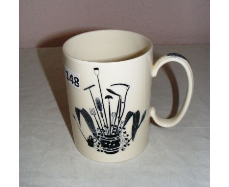 An Eric Ravilious of Wedgwood "Garden Implements" lemonade mug, decorated with a barrel full of garden tools highlighted in y
