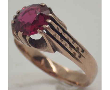 Large circular cut faceted ruby on an unusual yellow metal ring ruby approximately 1.5ct size U 5.2g