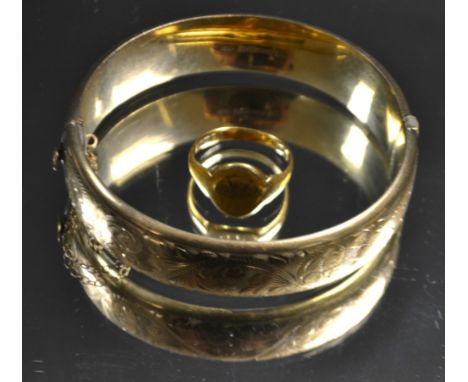 An 18ct gold signet ring, 5g; a 9ct gold hinged bangle, 19g (2)