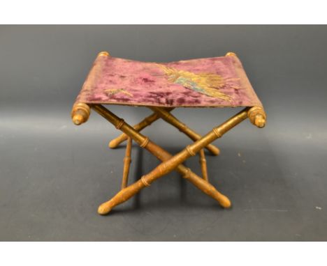 A 19th century folding book stand, tapestry top decorated with two birds, gilt bamboo effect legs, c.1880