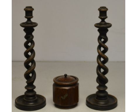 A large pair of treen twisted candlesticks, a treen tea caddy (3) 