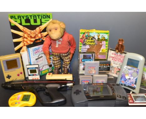 Toys and Juvenalia - a 1960s Japanese tin plate battery operated roller skating monkey;  an Atari Lynx hand held games consol