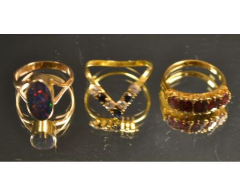 An 18ct gold five stone ruby ring; an 18ct gold diamond and gold opal cabochon ring, 9.5g gross