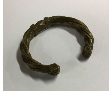 A heavy child's torque bangle. Est. £10 - £20.