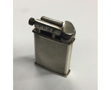 A solid Dunhill style lighter. Est. £80 - £120.