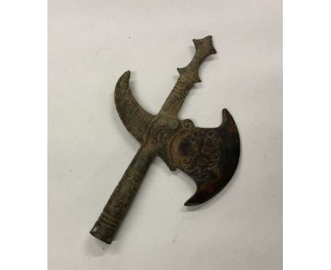 An Eastern axe head with carved stone blade. Est. £10 - £20.