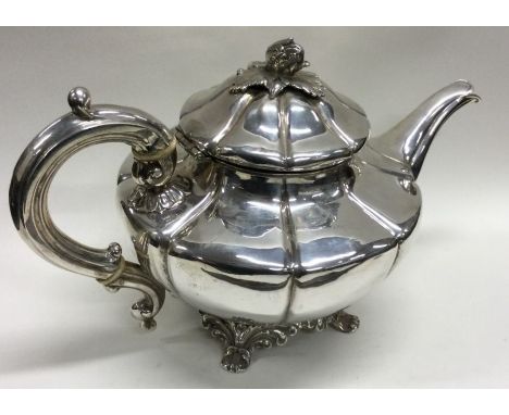 A fine quality panelled William IV silver teapot with chased flower finial. London 1838. Approx. 676 grams. Est. £450 - £550.