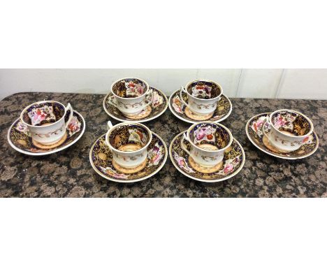 A set of six early porcelain cups and saucers decorated with flowers and gilding. Est. £20 - £30.