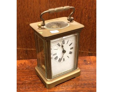 An old carriage clock. Est. £15 - £20.
