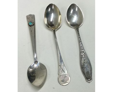 A selection of three various silver spoons, to include one inset with a stone; one of shooting interest and another depicting