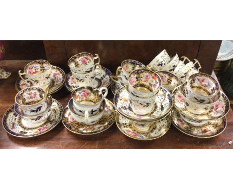 A good matched set of early English cabinet cups and saucers decorated in bright colours with flowers and gilding. Est. £60 -