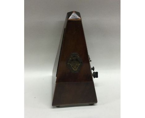 An old metronome. Est. £10 - £20.