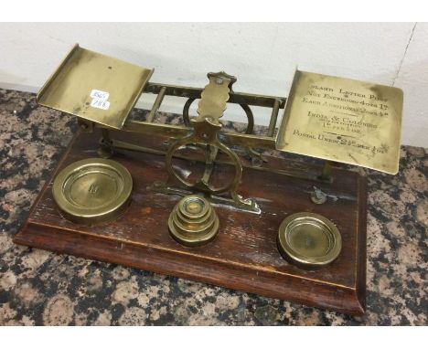 A large set of brass postal scales. Est. £30 - £40.