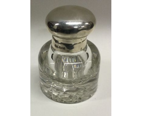 A heavy silver and glass inkwell. Sheffield 1918. By James Dixon and Sons. Est. £60 - £80.