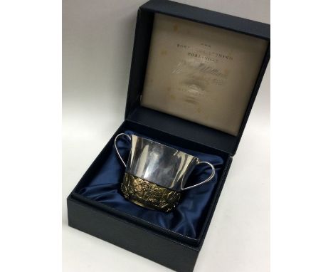 STUART DEVLIN: A rare cased silver porringer of chased floral design to commemorate the christening of Prince William. London