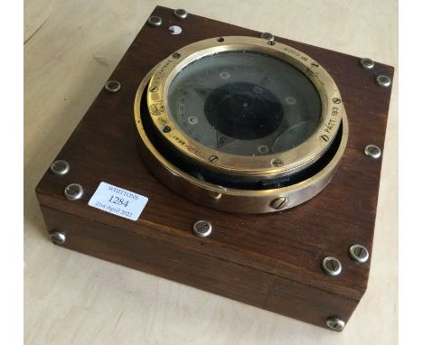 An old brass travelling ships compass. Est. £40 - £60.