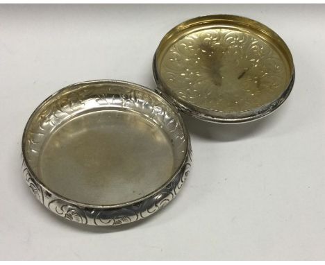 A heavily engraved hinged top snuff box. Marked to base. Approx. 79 grams. Est. £50 - £80.