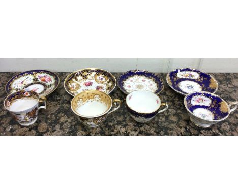A good selection of five attractive cabinet cups and saucers decorated in bright colours. Est. £25 - £35.