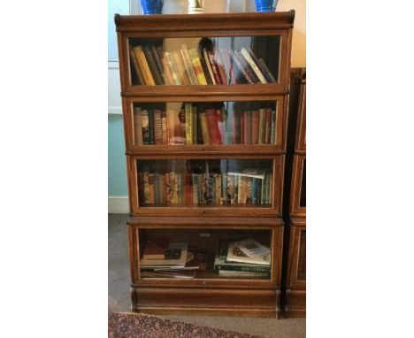 A four section oak Globe Wernicke bookcase. Est. £250 - £350.