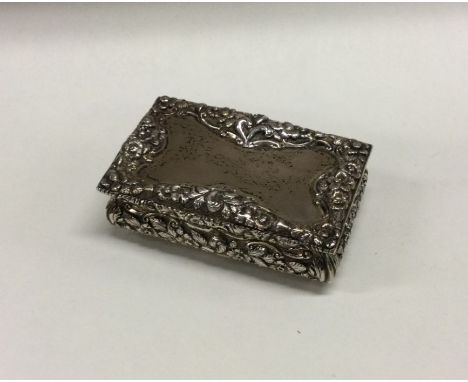 A chased silver snuff box with gilt interior. Birmingham 1841. By Nathaniel Mills. Approx. 99 grams. Est. £400 - £500.