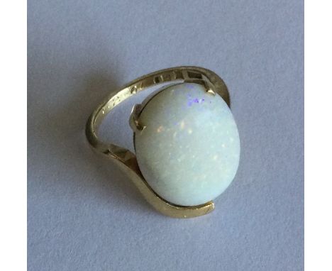 An opal single stone ring in 18 carat oval claw mount. Approx. 6 grams. Est. £30 - £40.