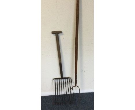 An old vintage hay fork together with one other. Est. £10 - £20.