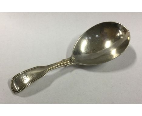 A silver fiddle pattern caddy spoon. London. By GS. Approx. 17 grams. Est. £30 - £40.