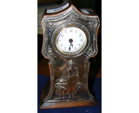 A 22cm high mantel clock timepiece with embossed silver front