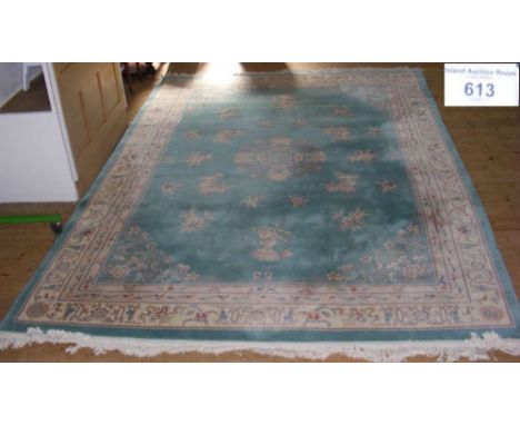 A 430cm x 295cm washed Chinese carpet with sea green ground, floral motifs and border