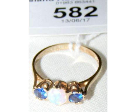 A 9ct gold three stone ring with centre opal flanked by two blue stones