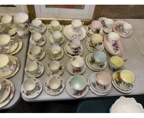 A LARGE COLLECTION OF CERAMIC CUPS AND SACUERS 