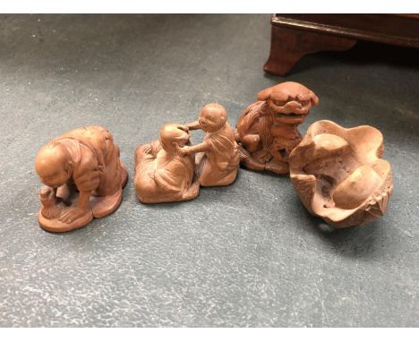 A GROUP OF FOUR BOXWOOD JAPANESE NETSUKE FIGURES 