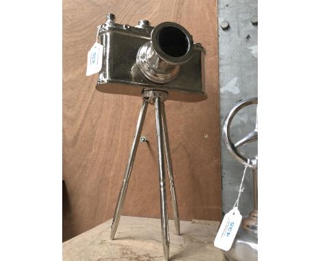 A VINTAGE CHROME CAMERA ON A STAND 