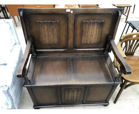 AN ELM MONKS BENCH WITH LINEN FOLD PANELS 