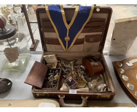 A VINTAGE SUITCASE AND CONTENTS, INCLUDING COSTUME JEWELLERY, SASH ETC 