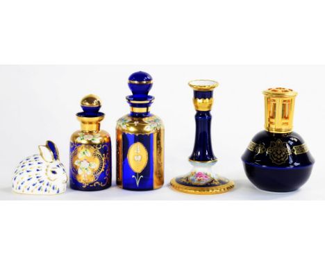 A LIMOGES COBALT GROUND PORCELAIN CANDLESTICK, 15CM H, TWO VENETIAN GILT BLUE GLASS SCENT BOTTLES AND STOPPERS, A ROYAL CROWN