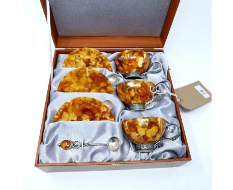 A set of three Russian silver and natural amber cups and saucers, with spoons, in original box 